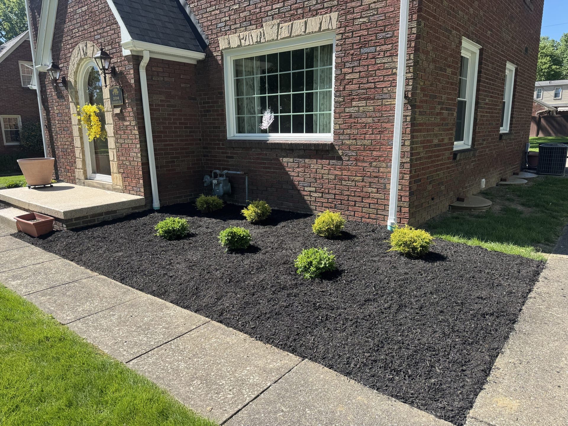 Refreshed mulch beds after landscaping