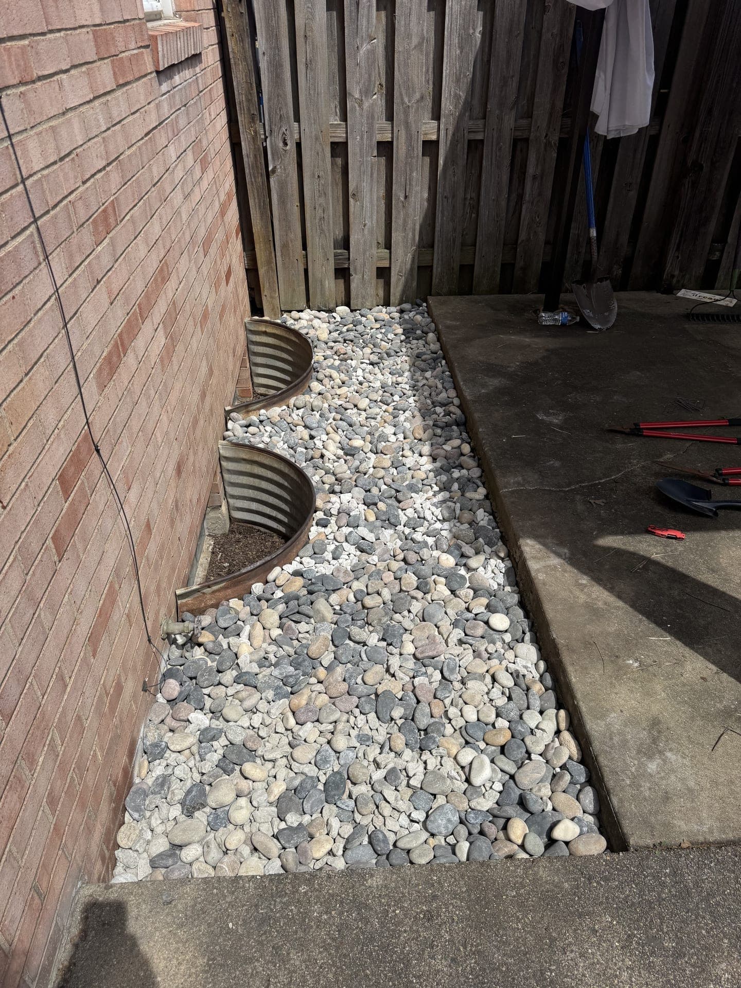 Clean decorative rock bed after landscaping